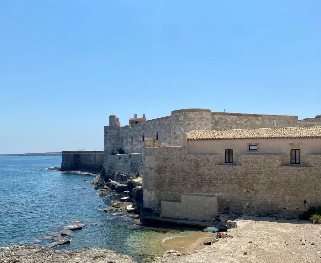 This image has an empty alt attribute; its file name is chap-on-his-own-private-beach-by-castello-maniace.jpg